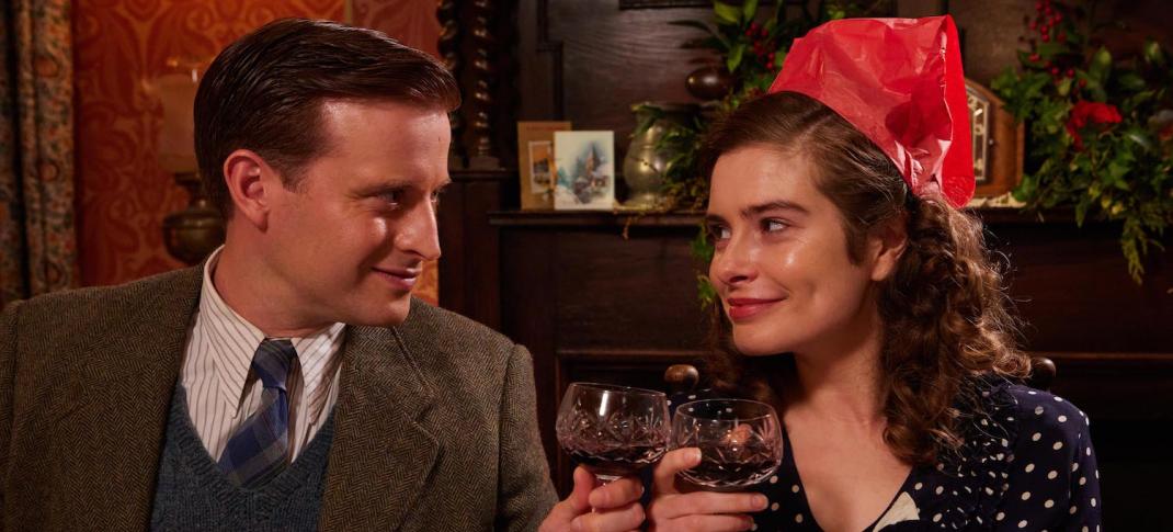 Picture shows: James (Nicholas Ralph) and Helen (Rachel Shenton), toast each other at Christmas dinner. She is wearing a very silly paper hat and they both look very happy.