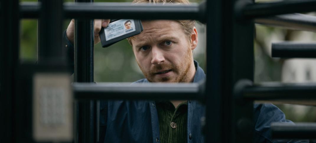 Jack Lowden as River Cartwright frustratedly showing his ID through a gate in 'Slow Horses' Season 3