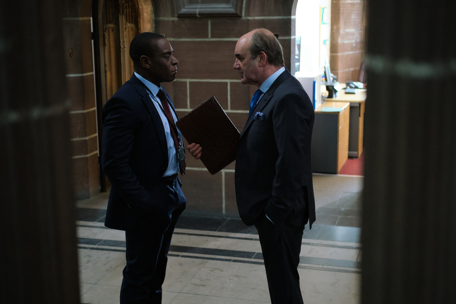 Joseph Obasi (Richard Pepple) and Archie Glover-Morgan (David Haig). Credit: Courtesy of © 2021 New Pictures Ltd