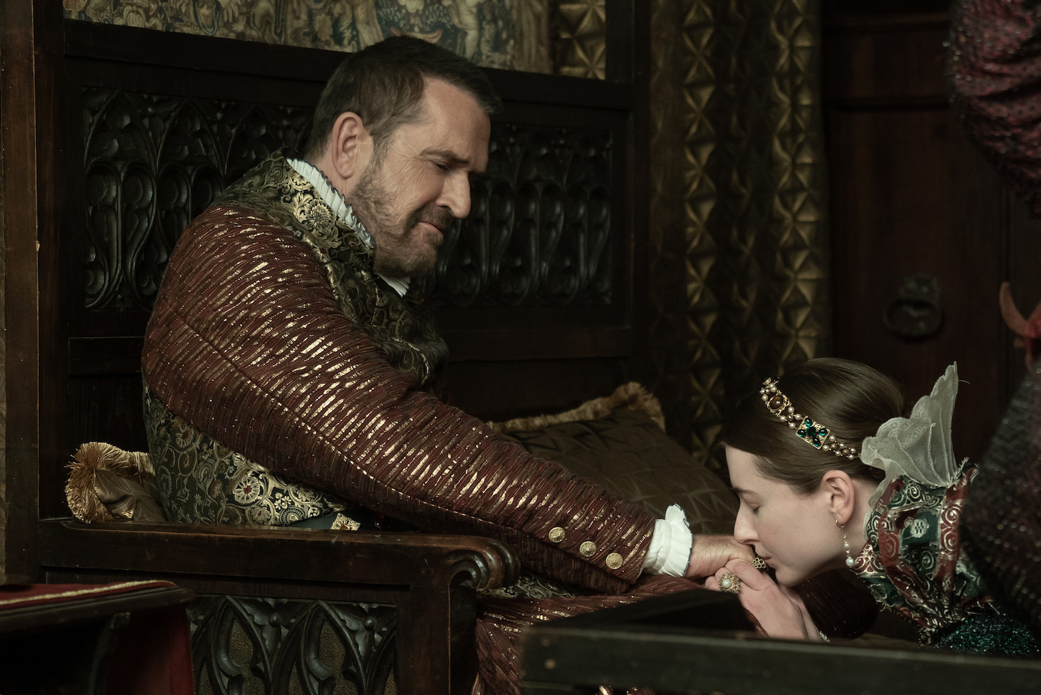 Picture shows: Picture shows: Mary (Antonia Clarke) kneels to kiss the hand of the Holy Roman Emperor (Rupert Everett), who seems to be really enjoying it