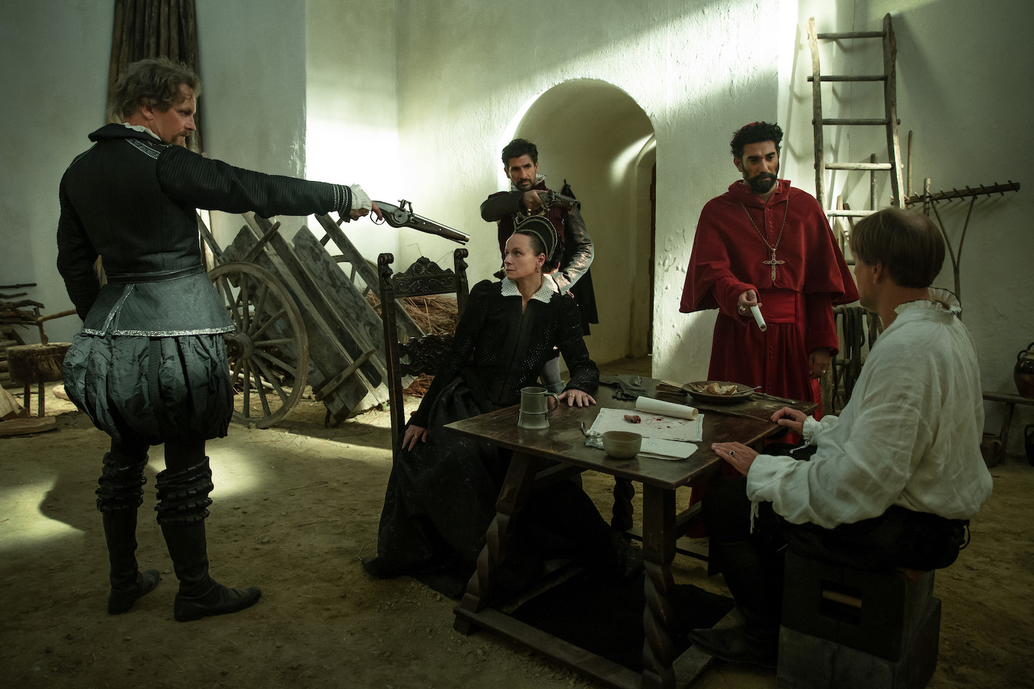 Picture shows: A standoff in a barn. Catherine (Samantha Morton) and Antoine de Bourbon (Nicholas Burns) are seated at a table while Montmorency (Barry Atsma) and Francois de Guise (Raza Jaffrey) threaten them with guns. Charles de Guise (Ray Panthaki) presents Antoine with the document they want him to sign which will eliminate his claim to the Regency.
