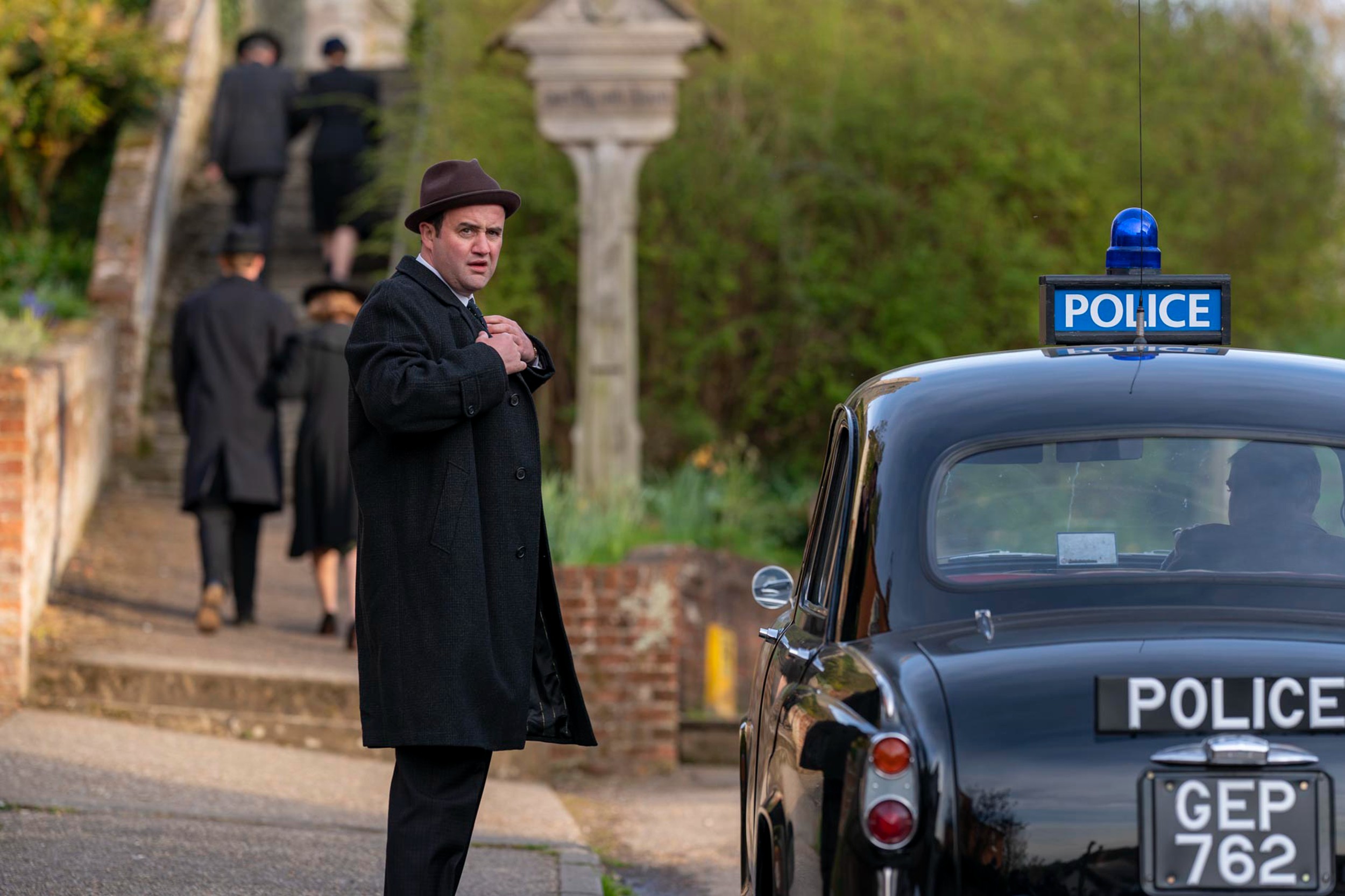 Picture shows: Daniel Mays as DI Chubb arriving at a funeral in PBS' 'Magpie Murders'