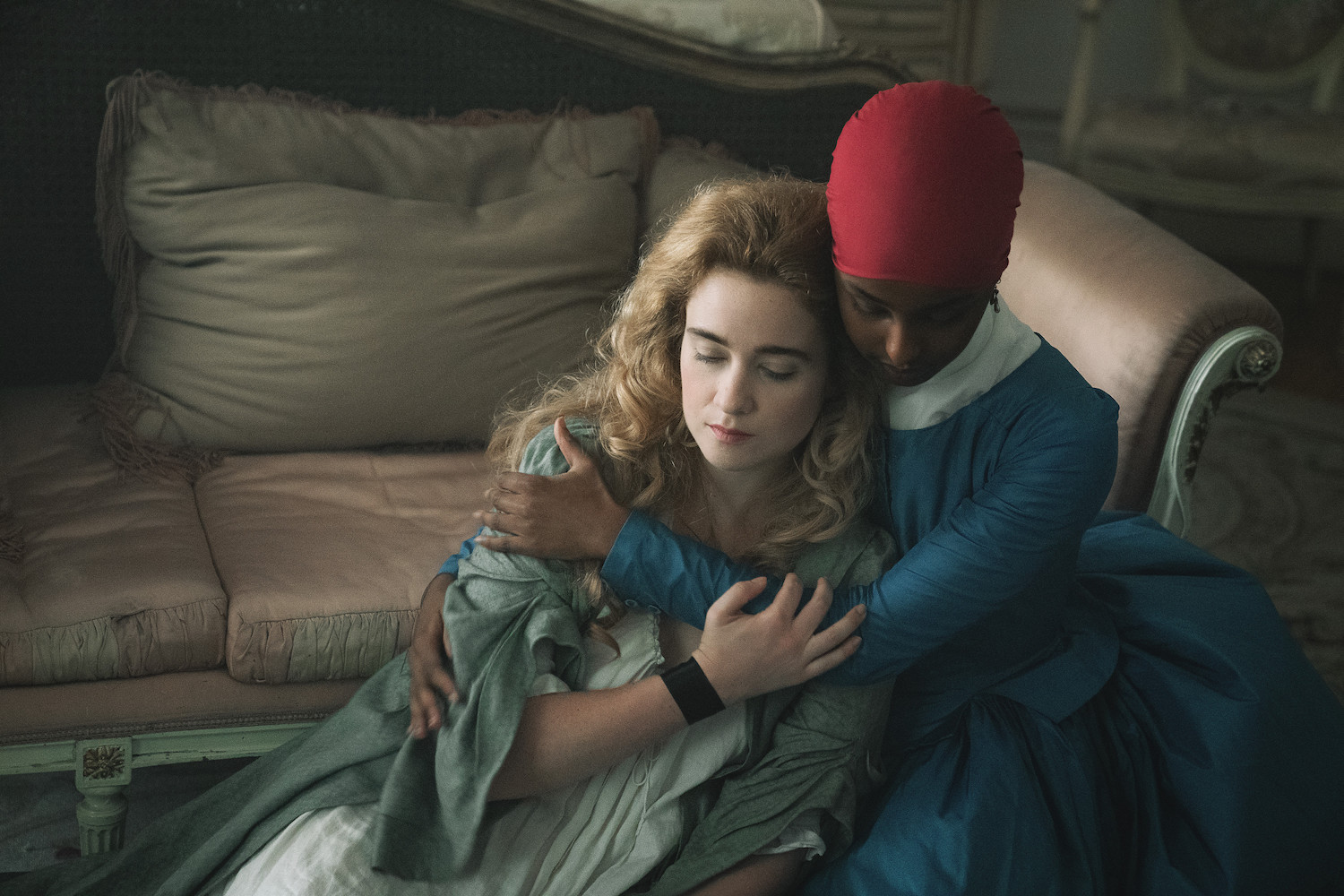 Picture shows: Victoire (Kosar Ali) and Camille (Alice Englert) seated on a sofa, seeking comfort.