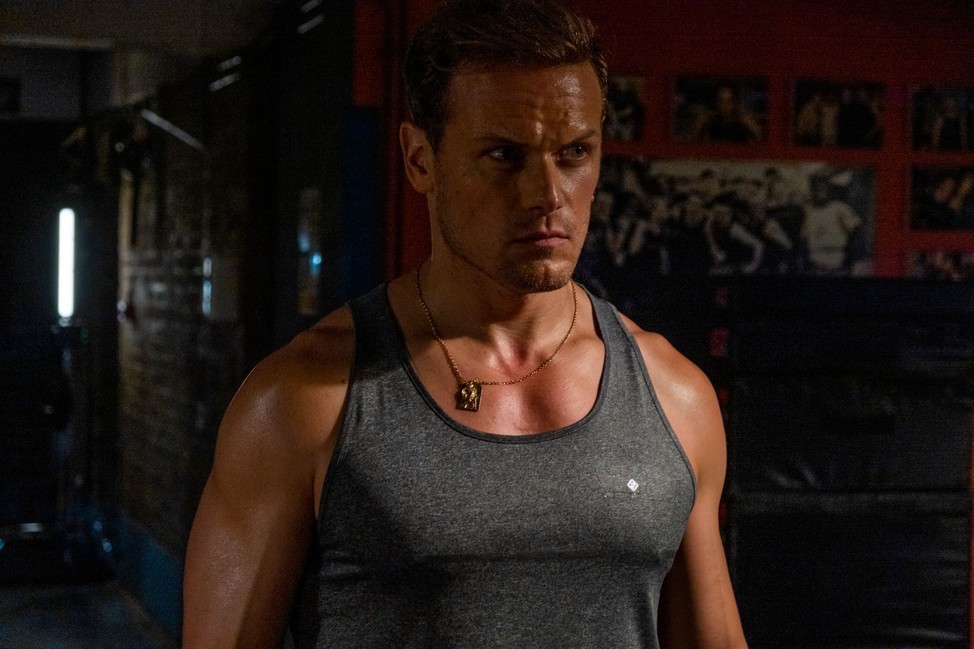 Picture shows: Ryan (Sam Heughan) all muscled and sweaty
