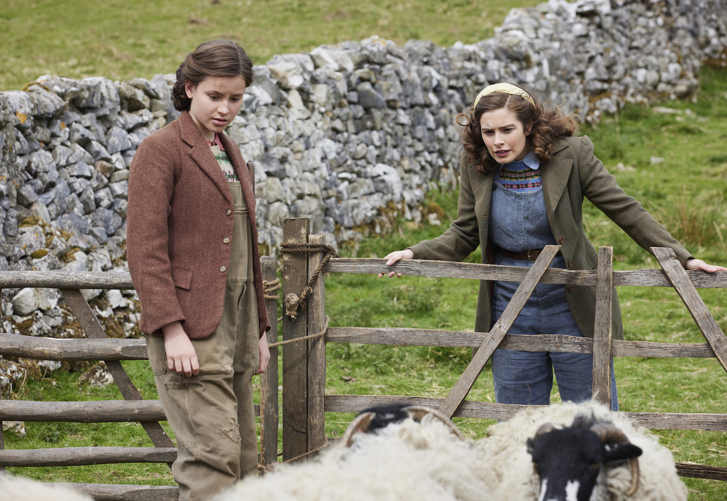 Picture shows: Helen (Rachel Shenton) admires the work her younger sister Jenny (Imogen Clawsen) has done on the farm. The two young women are looking over a fence at a flock of sheep.