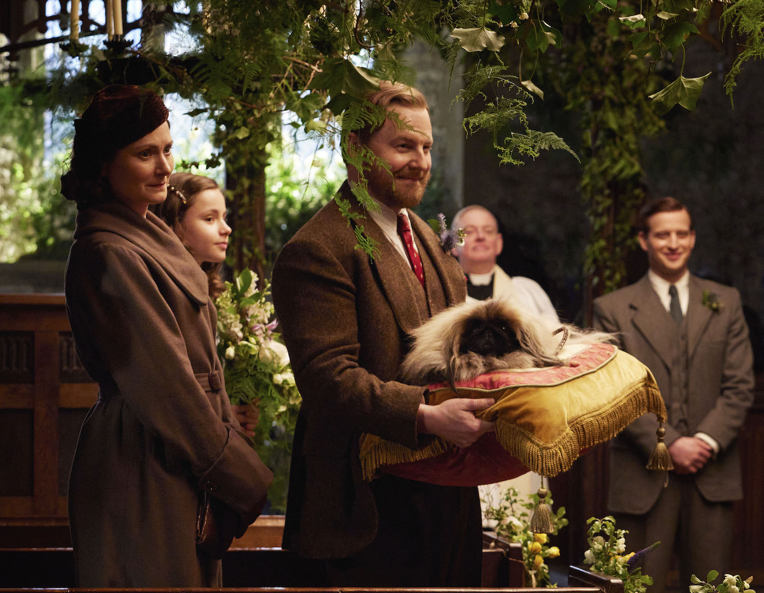 Picture shows: The wedding party. Mrs. Hall (Anna Madeley), Rachel Shenton (Imogen Clawsen), Siegfried Farnon (Samuel West), who holds the Pekinese Tricky Woo on a large pillow, and James Herriot (Nicholas Ralph) are finally ready for the wedding to take place.