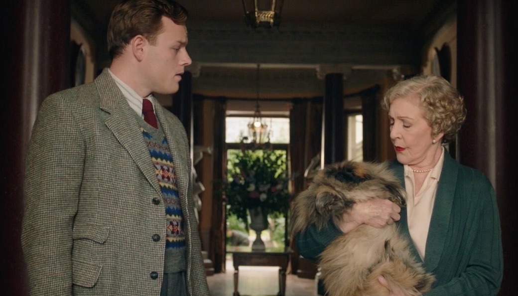 Picture shows: Tristan Farnon (Callum Woodhouse) talks to Mrs. Pumphrey (Patricia Hodge). She is holding a mass of fur which is Tricki Wu the Pekinese (Derek). They are standing in the hallway of her mansion, which opens onto a garden.