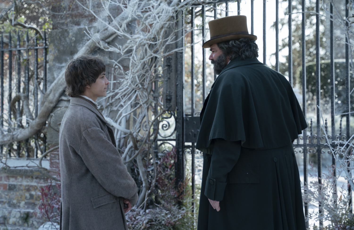 Picture shows: Mr. Pumblechook (Matt Berry) and Pip (Tom Sweet) at the gates of Satis House, with snow on the ground.