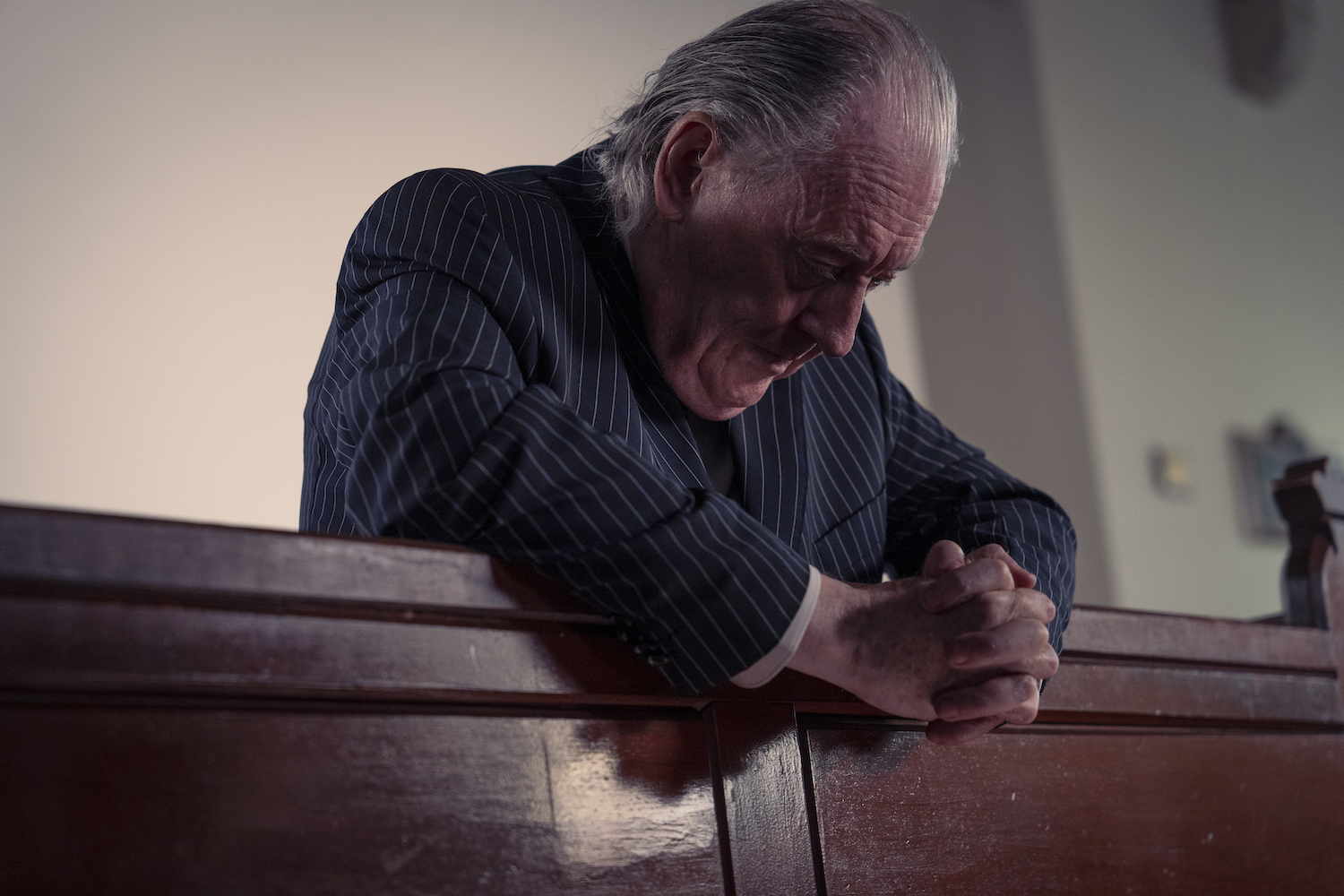 Picture shows: Head of Chambers Hubert Langton (Michael Culkin) praying and sitting slumped over a pew in the Chapel. 