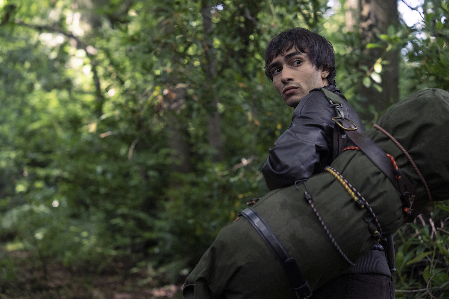 Picture shows: Garry Ashe (Yaseen Aroussi) carries a bedroll over his shoulder as he searches for a refuge in the woods.