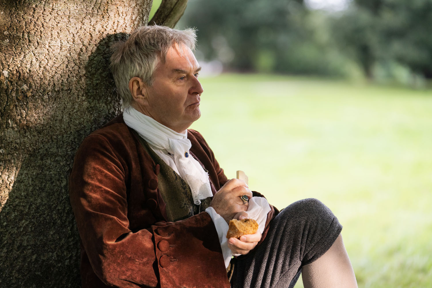 Picture shows: James Fleet as Squire Allworthy, seated under a tree on his estate and enjoying a snack.