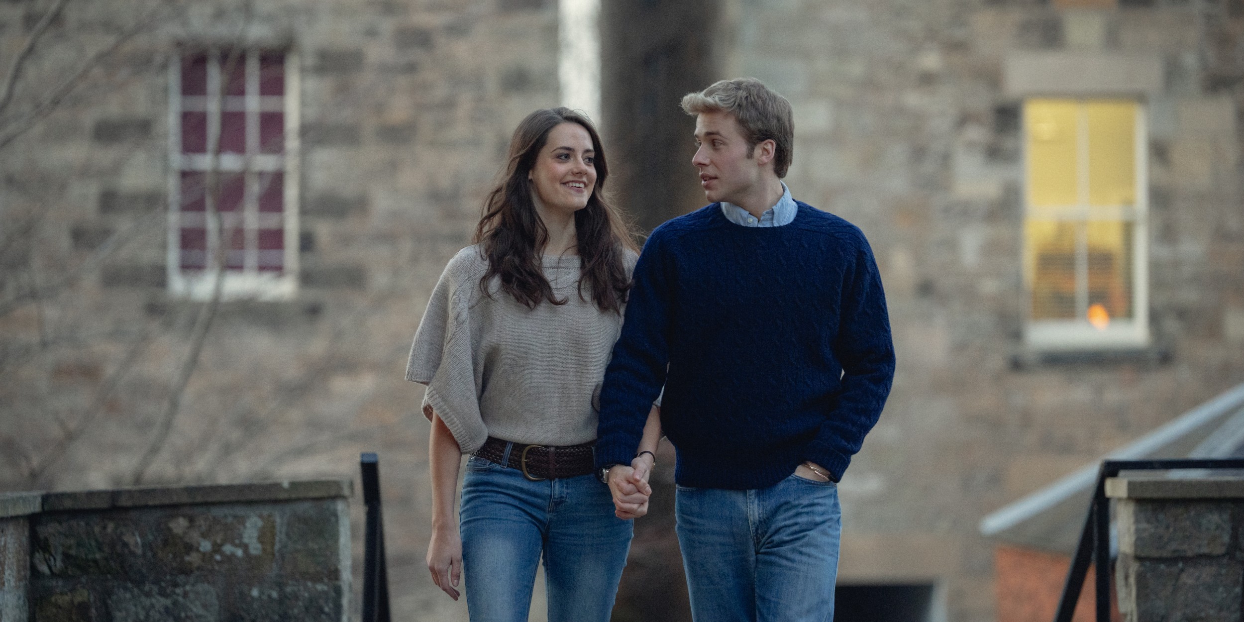 Meg Bellamy as Kate Middleton and Ed McVey as Prince William walking the grounds of Sandringham in 'The Crown' Season 6 