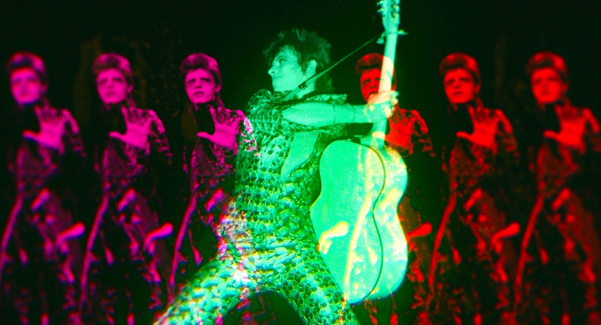 A Andy Warhol like triple image of David Bowie on guitar from Moonage Daydream