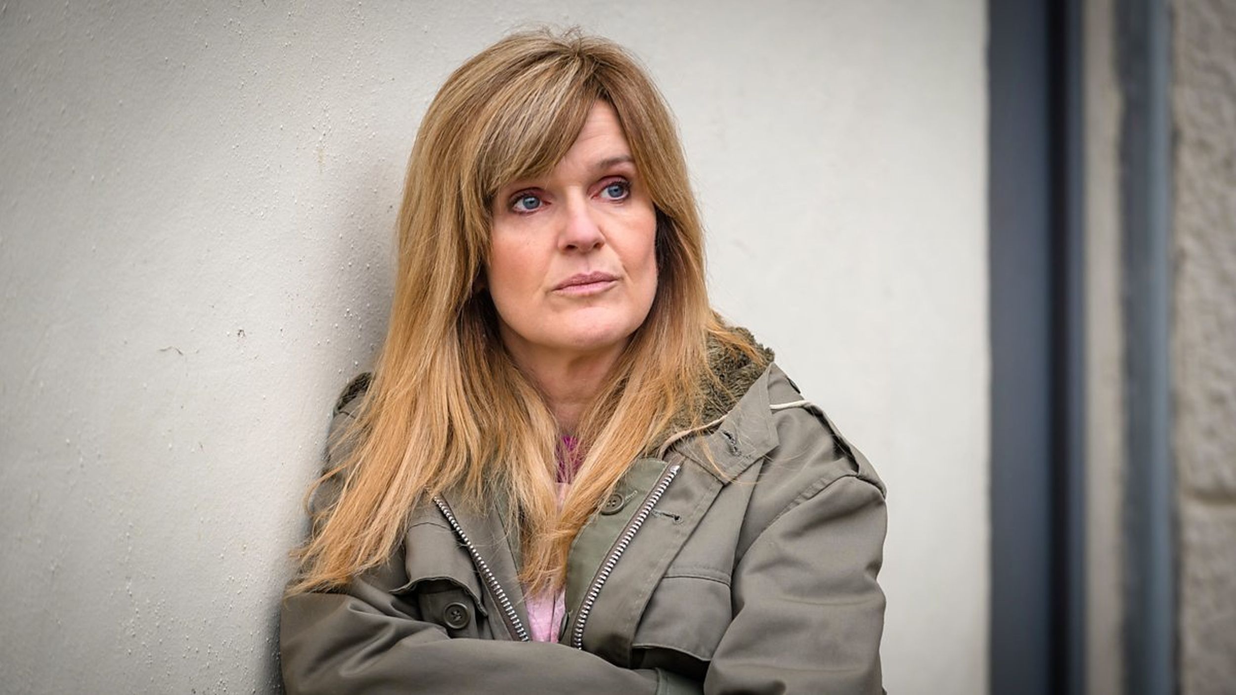Siobhan Finneran as Catherine's sister, Clare Cartwright, leaning against a wall at the police station 'Happy Valley' Season 1 