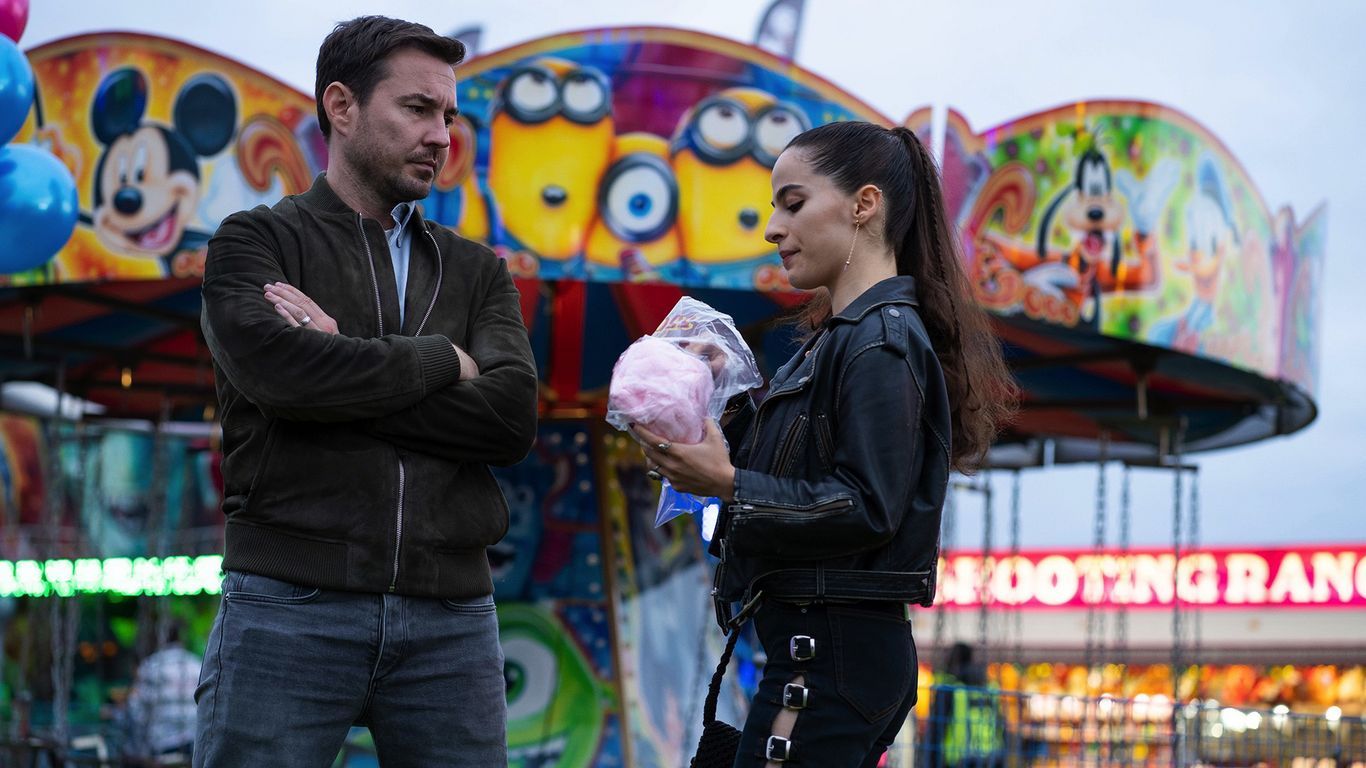 Picture shows: Wendy (Buket Komur) stalks Bram (Martin Compston) at the fun fair. She has a nice big armful of pink cotton candy which she is not about to share with him. 