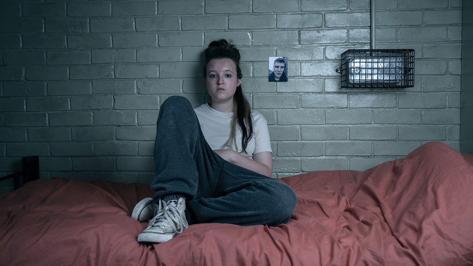 Bella Ramsey as Kelsey Morgan sits on her bed in Time Season 2