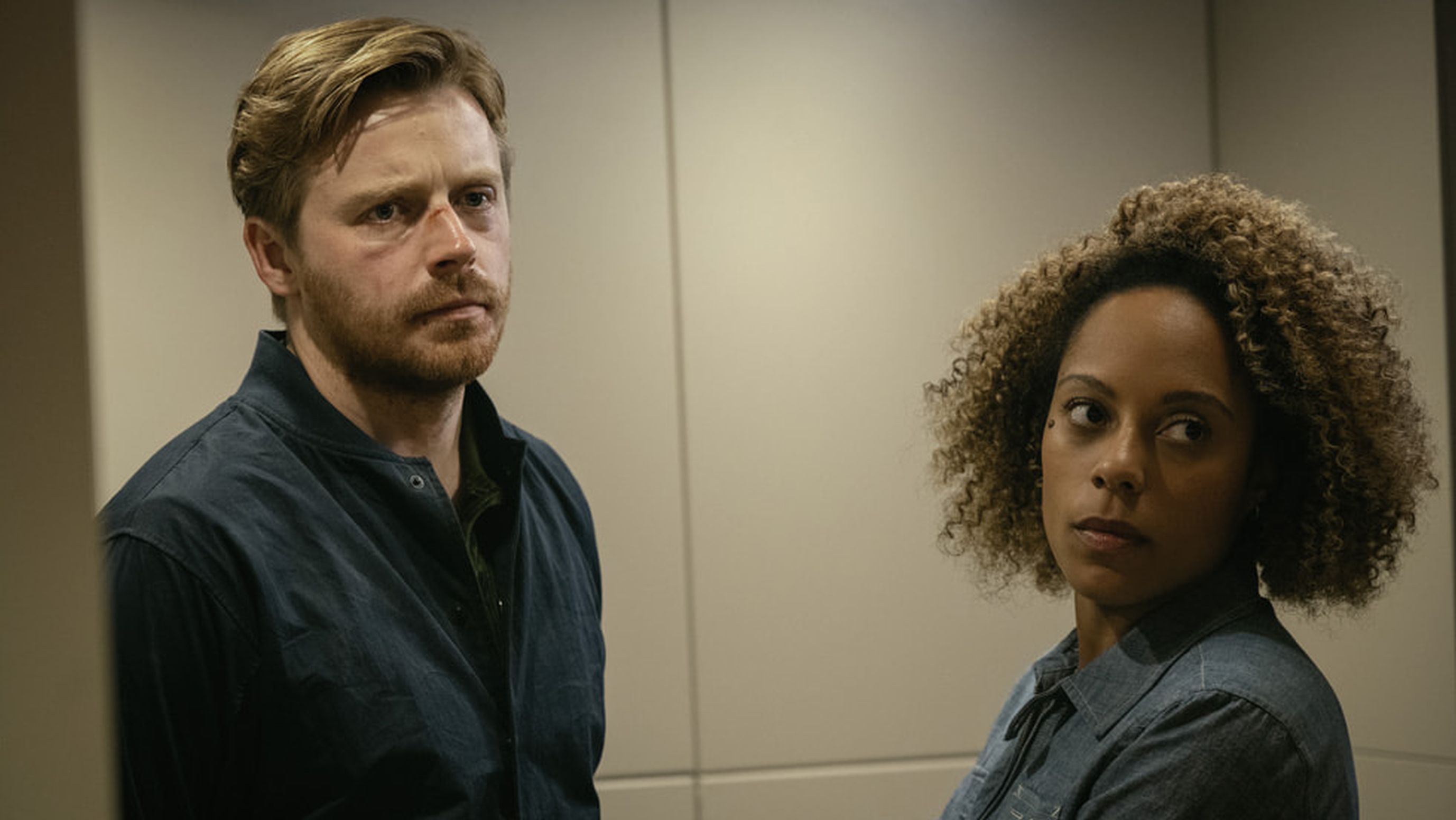Jack Lowden as River Cartwright and Rosalind Eleazar as Louisa Guy are interrupted in the hall in Slow Horses Season 3