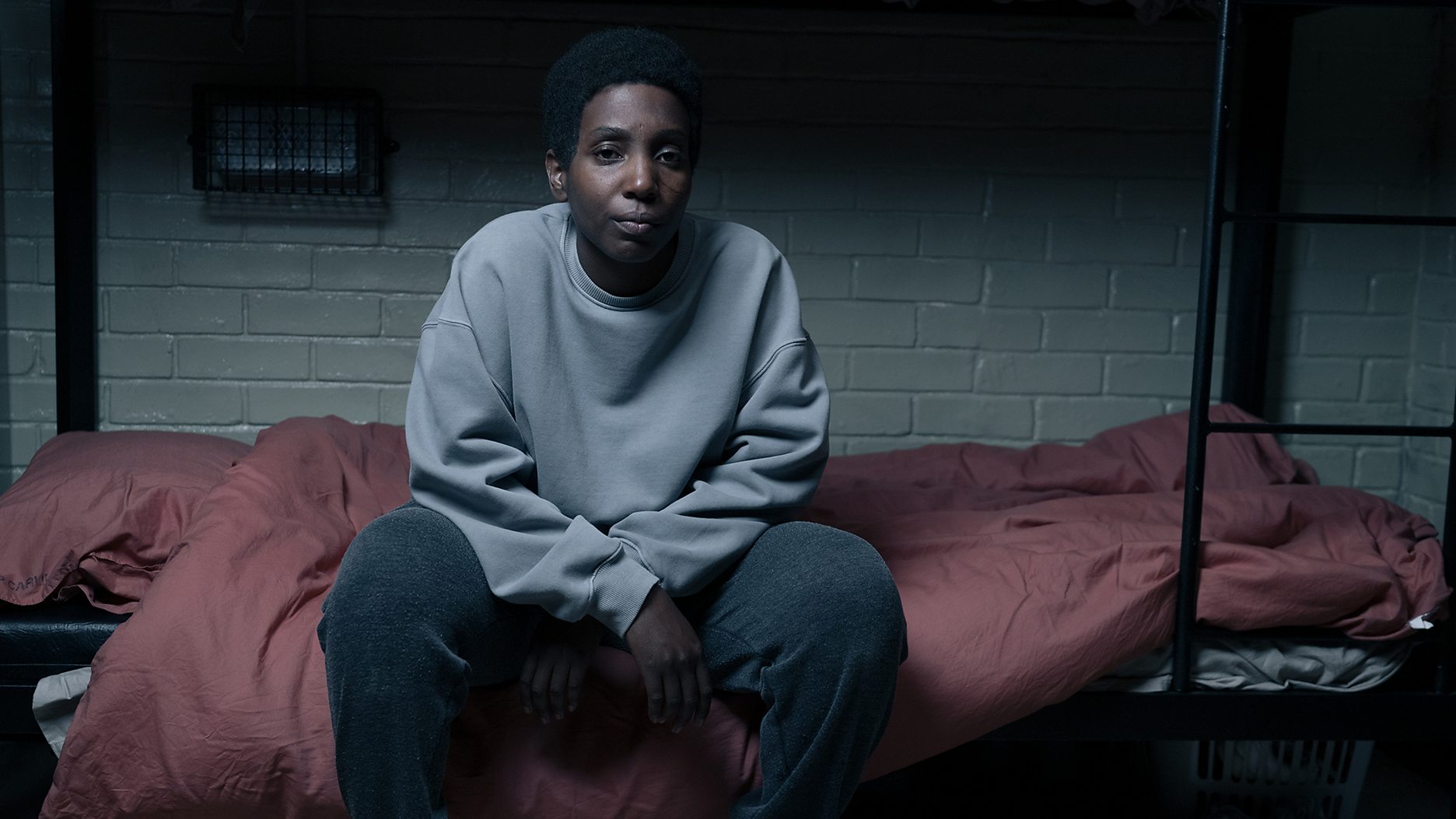 Tamara Lawrance as Abi Cochrane sits in her cell in 'Time' Season 2