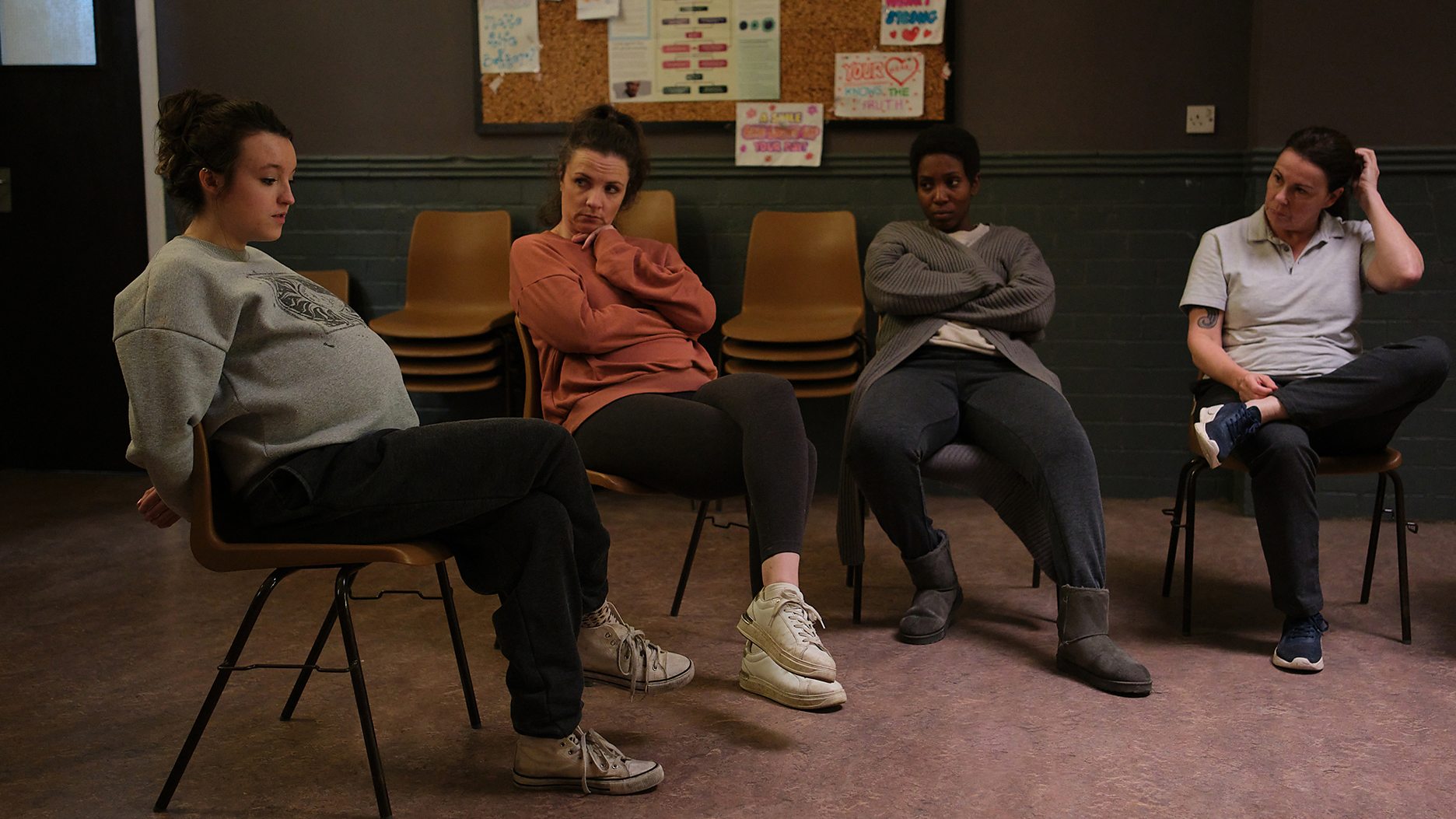 Bella Ramsey as a very pregnant Kelsey, sits in group therapy with fellow inmates played by Julie Graham, Tamara Lawrance, and Lisa Millett in 'Time' Season 2