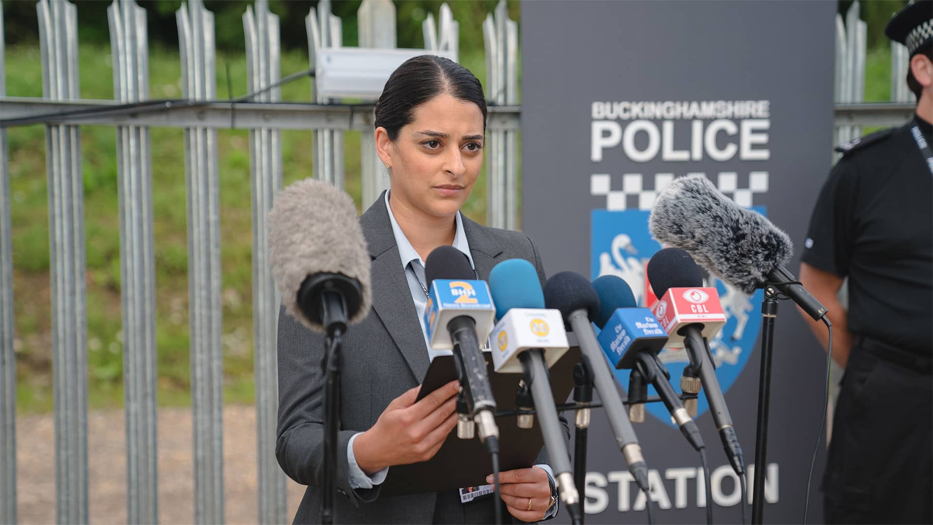 Natalie Dew as DS Tanika Malik giving a press conference in 'The Marlow Murder Club'