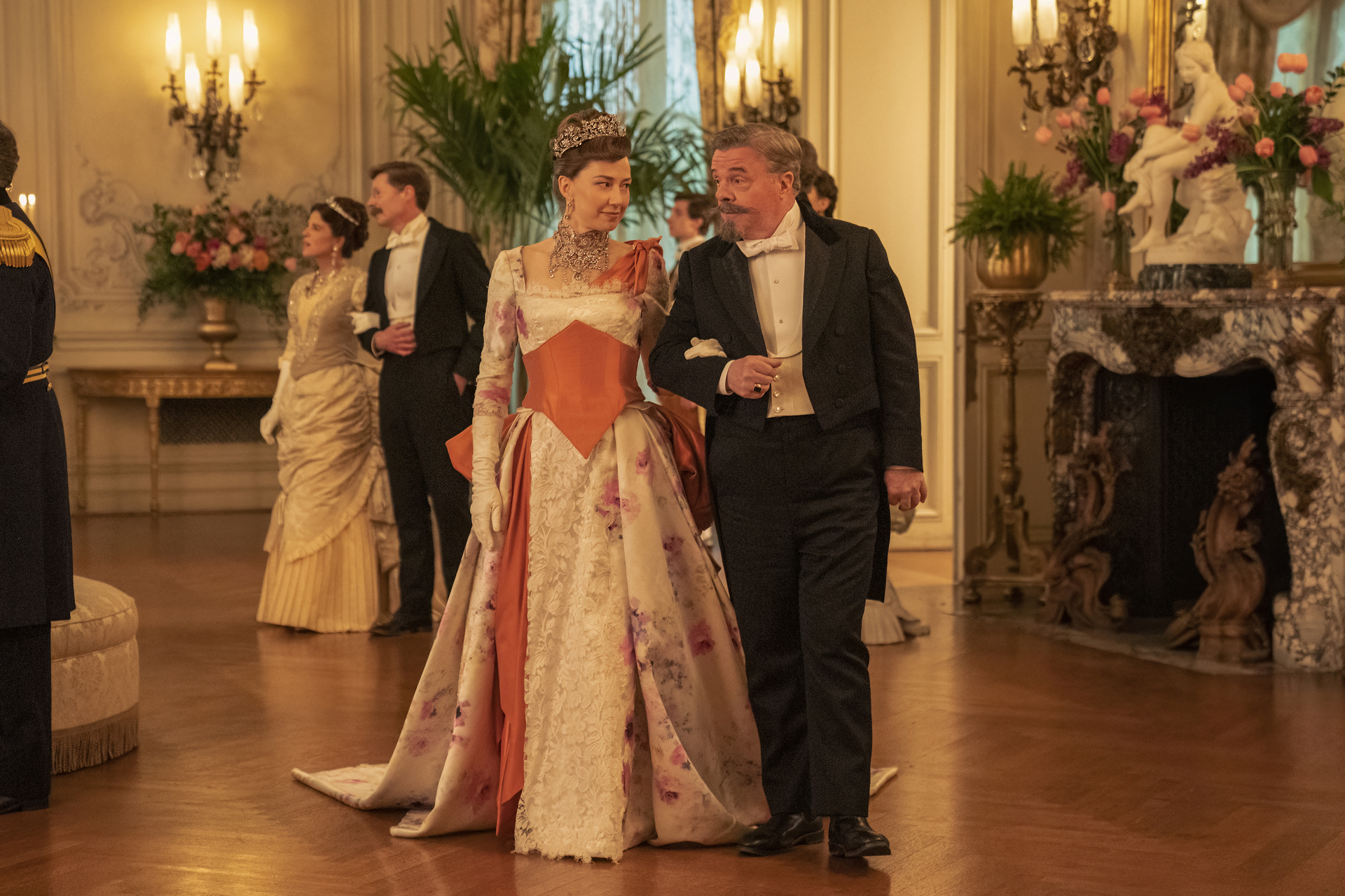 Carrie Coon as Bertha Russell and Nathan Lane as Ward McAllister victory lapping around the ballroom in 'The Gilded Age' Season 2