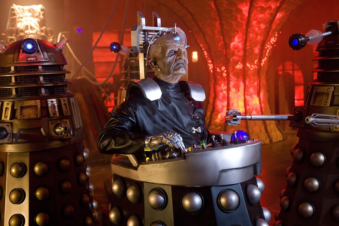 Davros in his Dalek casing, flanked by Daleks on either side