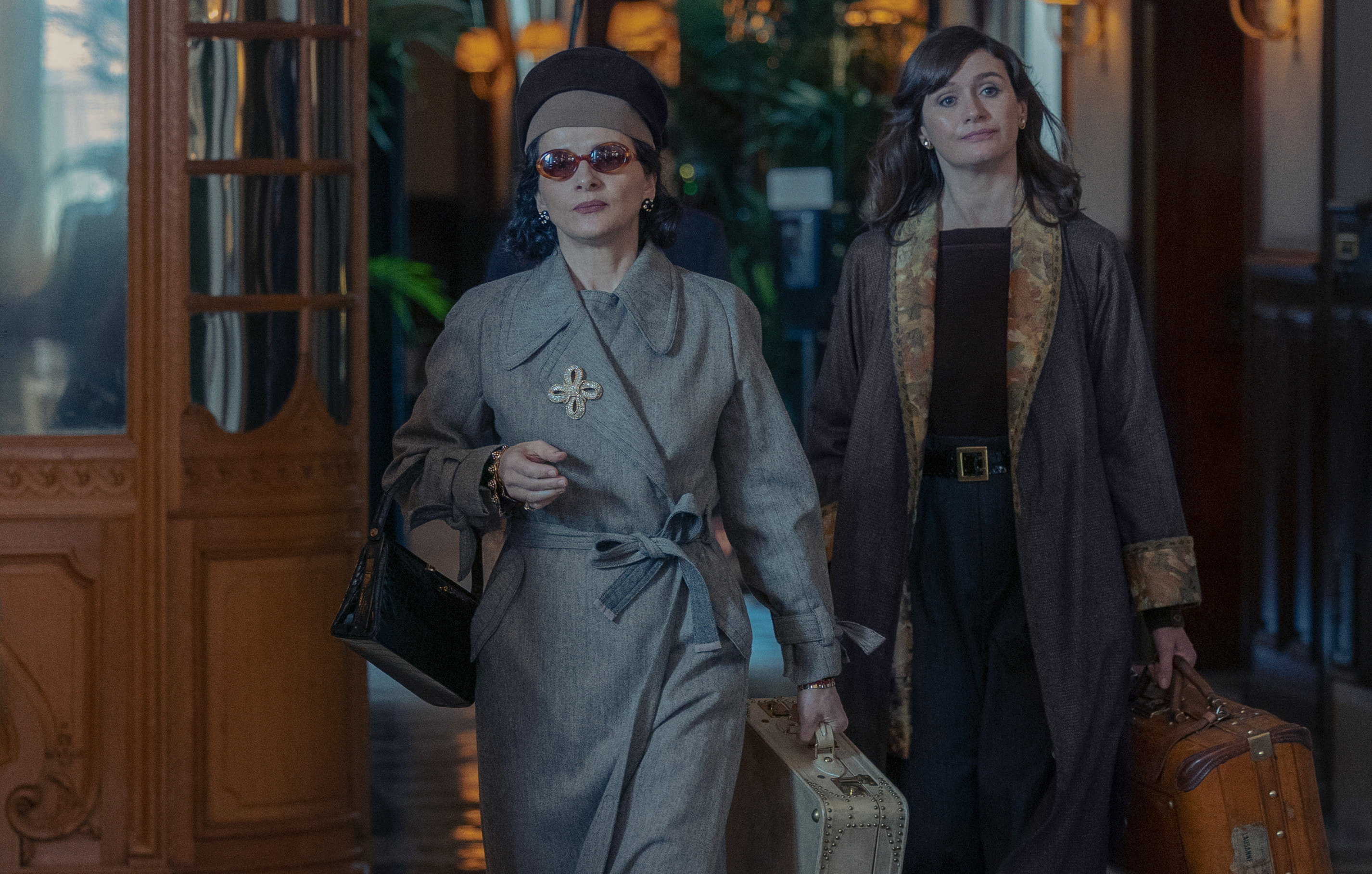 Juliette Binoche as Coco Chanel and Emily Mortimer as Elsa Lombardi walk into a hotel in 'The New Look' Season 1