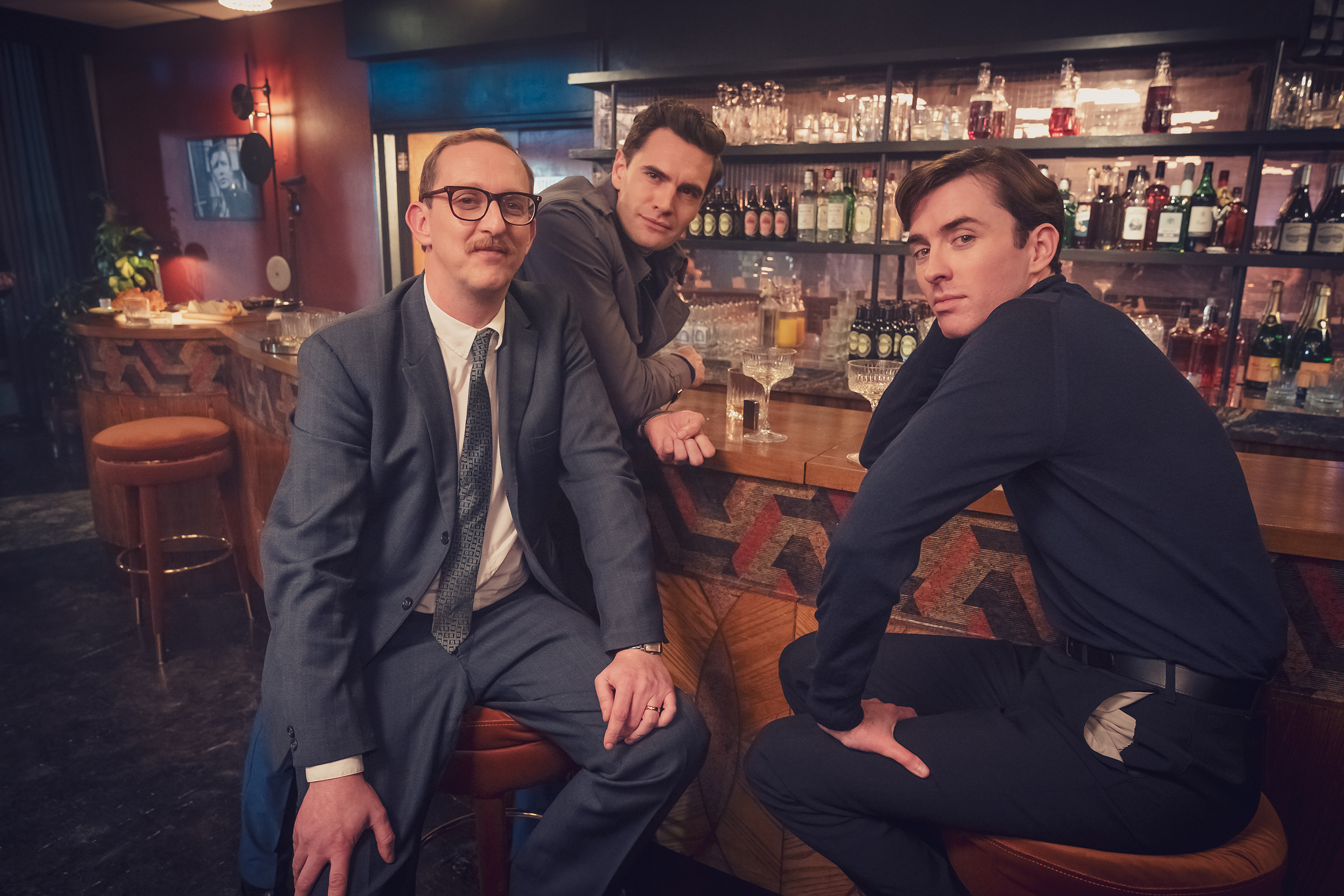 Leo Bill as Tony, Matthew Beard as Bill, and Tom Bateman as Clive pose together in Funny Woman Season 1