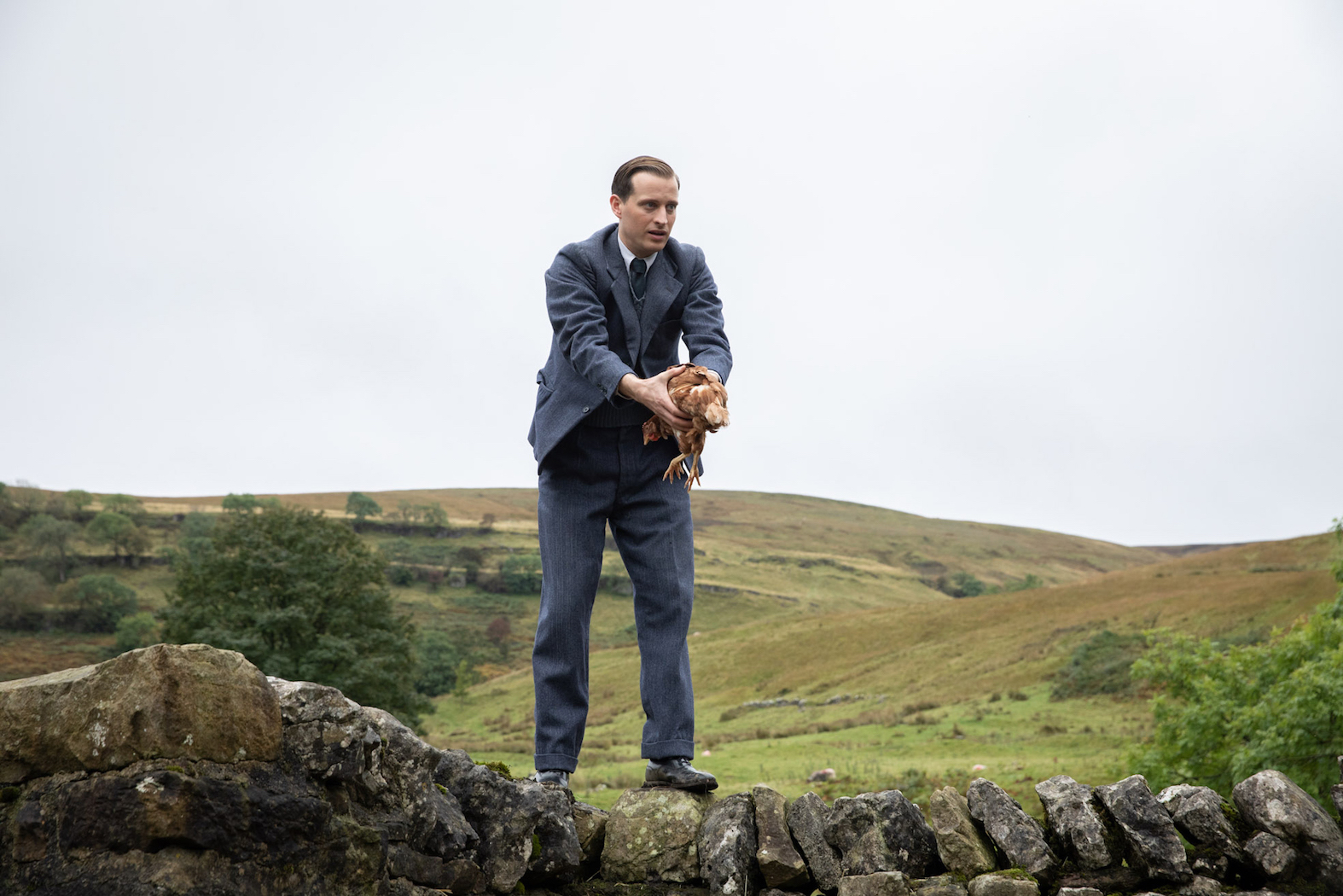 James Herriot (Nicholas Ralph) and a chicken. Credit: Courtesy of © Playground Television UK Ltd & all3media international