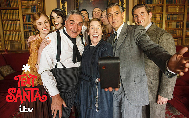 The cast of "Downton Abbey" takes a selfie with George Clooney during their “Text Santa” skit. (Photo: ITV/Nick Briggs)