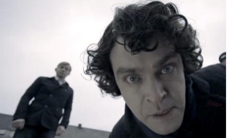 Vidar Magnussen in the role of Sherlock with Bjarte Tjøstheim in the background. (Photo: NKR, Screen Grab from YouTube)