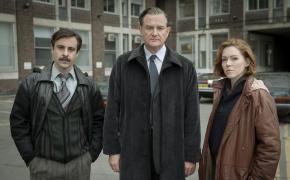 Emun Elliot as Tony Brightwell, Hugh Bonneville as Brian Boyce, Charlotte Spencer as Nicki Jennings pose outside the police precinct in 'The Gold'