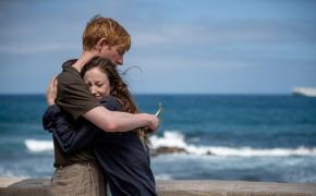 Domhnall Gleeson as Jack and Andrea Riseborough embrace by the ocean as Alice in 'Alice & Jack'