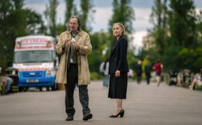 Gary Oldman as Jackson Lamb and Kristin Scott Thomas as Diana Taverner stand by an ice cream truck in the 'Slow Horses' Season 3 finale