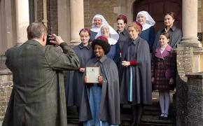 Clockwise from left: Natalie Quarry as Rosalind Clifford, Rebecca Gethings as Sister Veronica, Jenny Agutter as Sister Julienne, Laura Main as Shelagh Turner, Judy Parfitt as Sister Monica Joan, Linda Bassett as Nurse Phyllis Crane, and Renee Bailey as Joyce Highland get their photo taken in front of Nonnatus House in 'Call The Midwife' Season 13