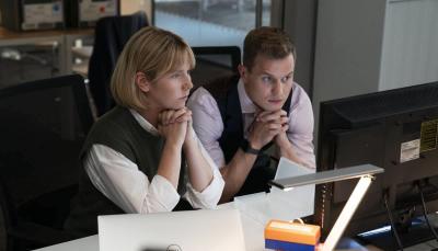 Picture shows: Karen Pirie (Lauren Lyle) and Jason "The Mint" Murray (Chris Jenks) sit side by side behind a desk looking at a computer screen
