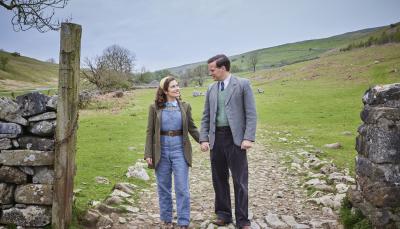 Picture shows: On a sunny day in the Dales, James (Nicholas Ralph) and Helen (Rachel Shenton) hold hands, paused on a rough track flanked by drystone walls. 
