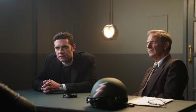 Tom Brittney as Will Davenport and Robson Green as Geordie Keating sit across from a suspect during an interrogation in 'Grantchester' Season 8  
