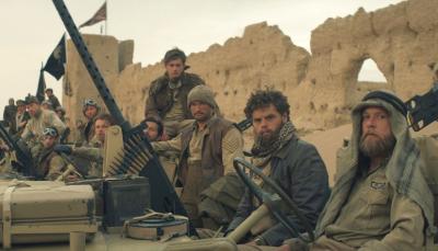 The cast of 'SAS Rogue Heroes' Season 1 sitting around on military equipment, waiting for WWII to begin