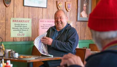 Mark Addy as Dave having breakfast at the diner in The Full Monty