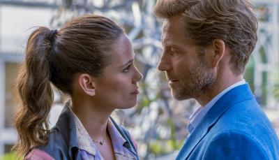 Harry King (Jamie Bamber) and Camille Delmasse (Lucie Lucas) look as though they're about to kiss.