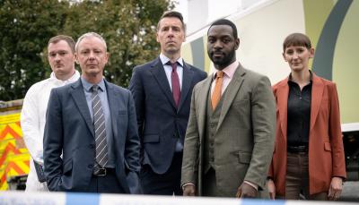 Brad Morrison as DC Nick Nicholls, John Simm as DS Roy Grace, Craig Parkinson as DS Norman Potting, Richie Campbell as DS Branson, and Laura Elphinstone as DS Bella Moy pose at the crime scene in Grace Season 3