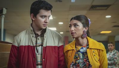 Asa Butterfield as Otis Milburn and Mimi Keene as Ruby Matthews walk together down a school hallway