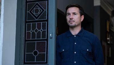 Picture shows: Bram Lawson (Martin Compston) at the front door of his house.