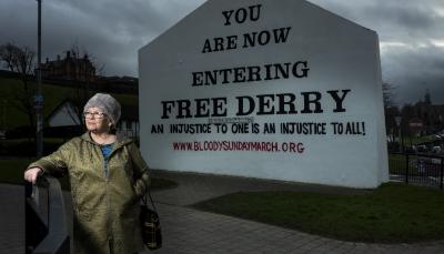 Kate, whose brother William was shot dead by paratroopers on Bloody Sunday, stands in front of the Free Derry sign in 'Once Upon A Time in Northern Ireland'