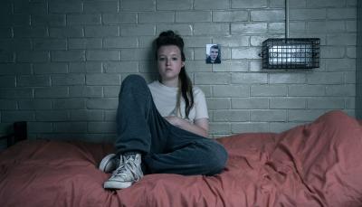 Bella Ramsey as Kelsey Morgan sits on her bed in Time Season 2