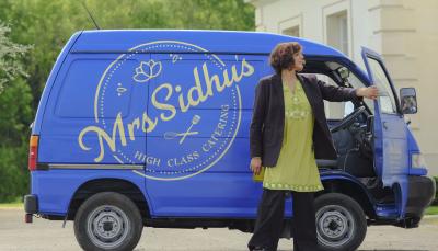 Meera Syal as Mrs. Sidhu stands in front of her food van in 'Mrs Sidhu Investigates' Season 1