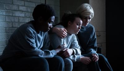 Tamara Lawrance as Abi Cochrane, Bella Ramsey as Kelsey Morgan, and Jodie Whittaker as Orla O'Riordan embrace in Time Season 2