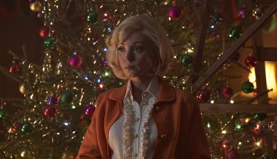 Helen George as Trixie Franklin in front of the Christmas tree in the Call The Midwife Season 13 Holiday Special