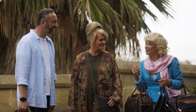 Steve Edge as Dom Hayes, Sally Lindsay as Jean White, and Sue Holderness as Judith Lloyd James arrive at the hotel in 'The Madame Blanc Mysteries' Season 3